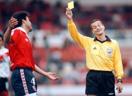 Castrilli le muestra la tarjeta amarilla al boliviano Óscar Sánchez, de Independiente, durante un partido contra River