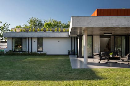 La vista de la casa desde el jardín, con sus líneas puras y materiales sin revestimiento.
