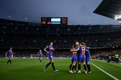 Las jugadoras del Barcelona celebran el tercer gol en la victoria 5-2 ante el Real Madrid en los cuartos de final de la Liga de Campeones femenina, el 30 de marzo de 2022, en Barcelona. (AP Foto/Joan Monfort)