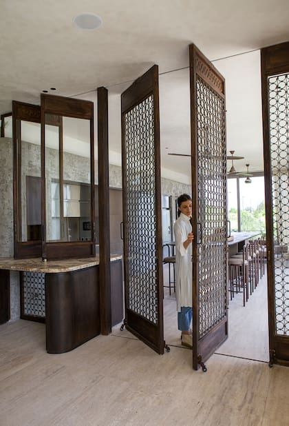 Las puertas que separan el comedor del quincho se trajeron de la India. A pesar de su gran tamaño, se giran y deslizan con suma facilidad.