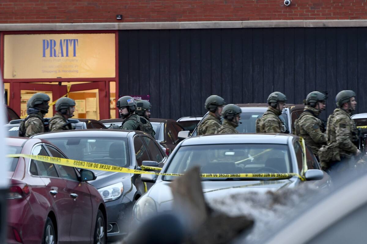 Law enforcement officers gather outside the Henry Pratt Co. manufacturing plant Friday, Feb. 15, 2019, in Aurora, Ill. Police say a gunman killed several people and injured police officers before he was fatally shot. (AP Photo/Matt Marton)