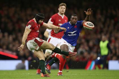 El eximio pateador galés Leigh Halfpenny se anticipa a la marca de Demba Bamba.