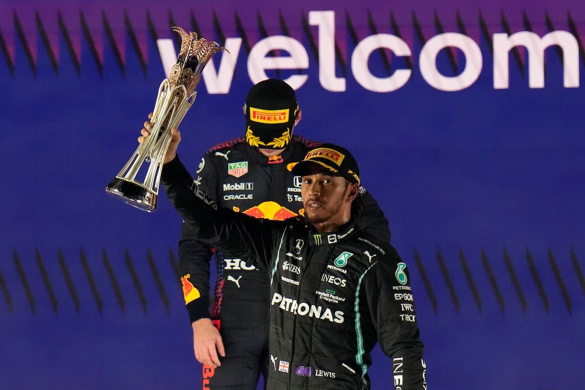Lewis Hamilton celebra la victoria en el Gran Premio de Arabia Saudita; detrás, Max Verstappen evita mantener contacto visual con el vencedor y contra quien definirá el título del Mundial de Pilotos el domingo en Abu Dhabi