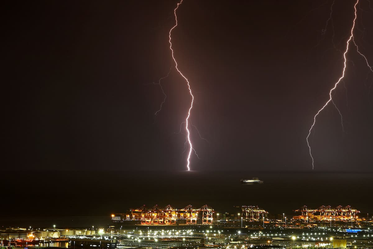 Lightning is striking in front of the port of Barcelona, while a ship is sailing, in Barcelona, Spain, on August 14, 2024. (Photo by Joan Valls/Urbanandsport /NurPhoto via Getty Images)