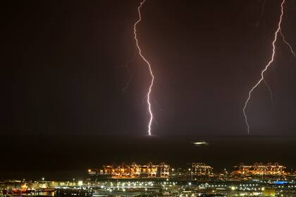 Lightning is striking in front of the port of Barcelona, while a ship is sailing, in Barcelona, Spain, on August 14, 2024. (Photo by Joan Valls/Urbanandsport /NurPhoto via Getty Images)