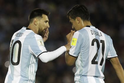 Lionel Messi charla con Paulo Dybala, en un encuentro contra Uruguay, en Montevideo, en 2017. (AP Photo/Matilde Campodonico)