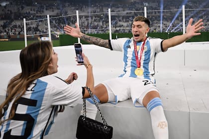 Lisandro Martínez, emocionado, posa para su novia, Muri López Benítez. Luego, festejaron en la cancha con los padres de los dos.