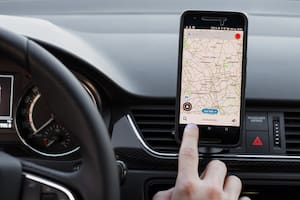 LOS ANGELES, CALIFORNIA - JUNE 6, 2019: Close up to male driving and using navigation appliction Google Maps. Get direction. An illustrative editorial image