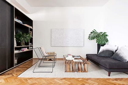 Además de bloquear la vista de la cocina, la biblioteca se complementa con el sillón para enmarcar el área del living y definir una impronta elegante y sintética.