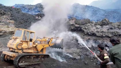 Los bomberos italianos intentan desviar la lava del Etna con agua y maquinaria