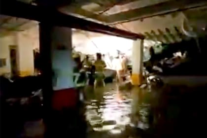 Los bomberos y rescatistas trabajan en el sótano inundado del edificio de Miami-Dade