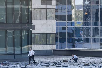 Los investigadores examinan un área junto a un edificio dañado en el distrito de negocios "Moscow City" después de un informe de ataque con drones en Moscú, Rusia, el martes 1 de agosto de 2023.