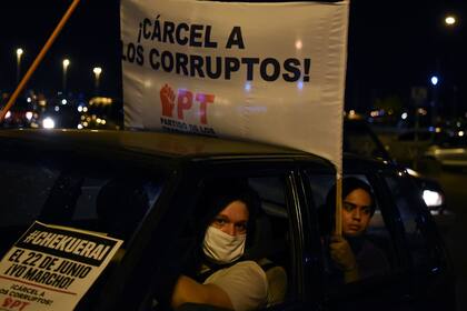 Manifestantes sostienen un cartel que dice "Cárcel a los corruptos" durante una protesta contra la corrupción generalizada y el desempleo en Asunción, Paraguay.
