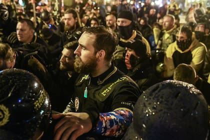 Los miembros de Proud Boys oran por un miembro que fue apuñalado durante una protesta el 12 de diciembre de 2020 en Washington, DC