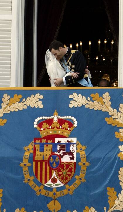 Los novios se abrazan en el balcón del Palacio Real de Madrid. A pesar de la insistencia del público presente en la plaza de Oriente, a todo lo que llegaron los novios fue a un casto beso, que decepcionó a los presentes después de horas de espera