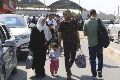 Los palestinos esperan en el cruce fronterizo de Rafah, entre la Franja de Gaza y Egipto (AP/Hatem Ali)