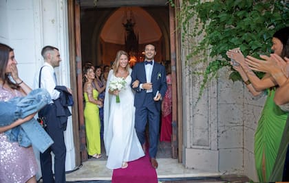 Los recién casados a la salida de la capilla de “La Concepción”, la estancia de la familia Blaquier, en Lobos. Agustina diseñó su vestido de novia con Andrea “Tucu” Martínez, la mujer de su padre. “La confección estuvo a cargo de la misma modista que me hizo el vestido para mi fiesta de 15, y usamos retazos de encaje del vestido de novia de mi mamá”, contó. Además, llevó sandalias Unützer diseñadas por su marido y un collar con un dije de corazón azul que perteneció a la abuela de Pampa. Su maquillaje y peinado fue obra de Jorge Jacome.