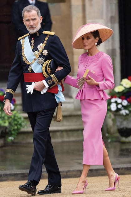 Los reyes de España al llegar a la abadía. Felipe VI, con el uniforme de gala de capitán general de los ejércitos, con las cuatro grandes cruces militares, el Toisón de Oro y el de la Orden de la Jarretera. La reina Letizia, con total look de Carolina Herrera, salvo el sombrero, de Balel Luxury Hats.