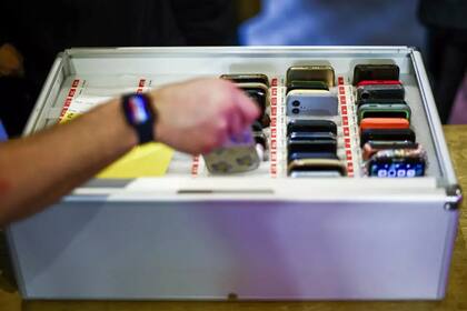Los teléfonos de los participantes en una velada del "Offline club" son dejados por sus propietarios en una caja, el 12 de febrero de 2025 en Londres. © HENRY NICHOLLS / AFP