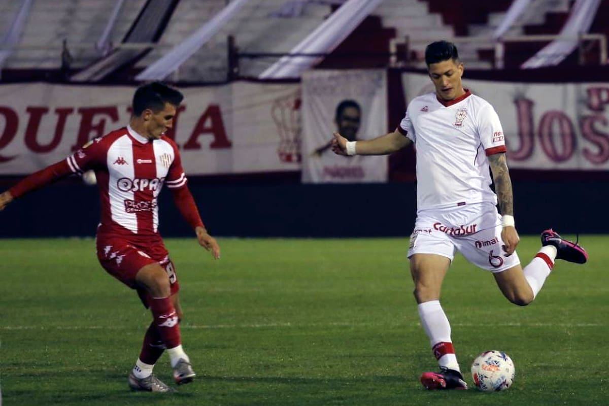 Lucas Merello, defensor central de Huracán, intenta una salida desde el fondo ante la marca de Daniel Juárez, delantero de Unión, por la 6° fecha del Torneo 2021