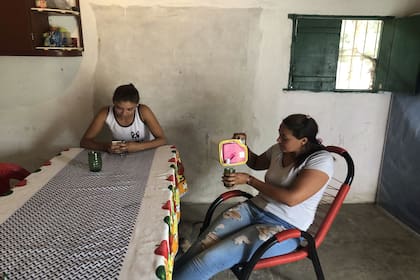 Luisa comparte un tereré con su hija Micaela, quien la ayuda a hacer las tareas de la casa y los mandados.