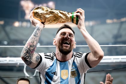 LUSAIL CITY, QATAR - DECEMBER 18: Lionel Messi of Argentina celebrates victory with the trophy after the FIFA World Cup Qatar 2022 Final match between Argentina and France at Lusail Stadium on December 18, 2022 in Lusail City, Qatar. (Photo by Marvin Ibo Guengoer - GES Sportfoto/Getty Images)