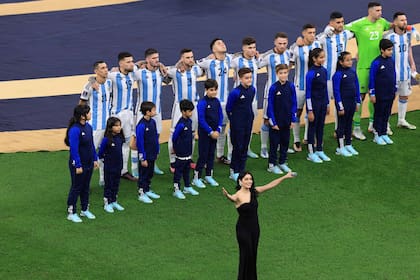 LUSAIL CITY, QATAR - DECEMBER 18: Singer Lali Esposito sings the national anthem in front of Argentina players line up for the national anthem prior to the FIFA World Cup Qatar 2022 Final match between Argentina and France at Lusail Stadium on December 18, 2022 in Lusail City, Qatar. (Photo by Buda Mendes/Getty Images)