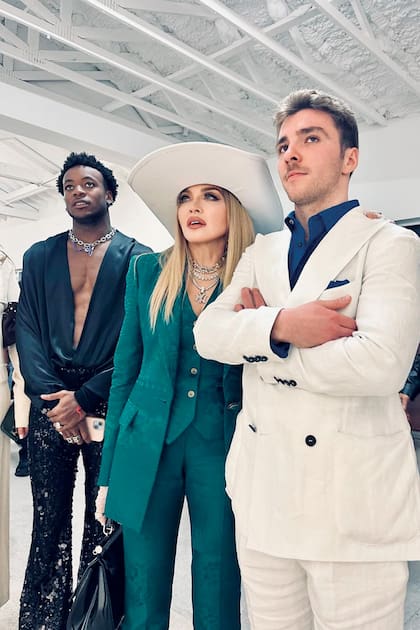 Madonna –con un traje con estampado en motivos florales de Roberto Cavalli y sombrero Ruslan Baginskiy–, posa con sus hijos varones, David Banda y Rocco Ritchie.