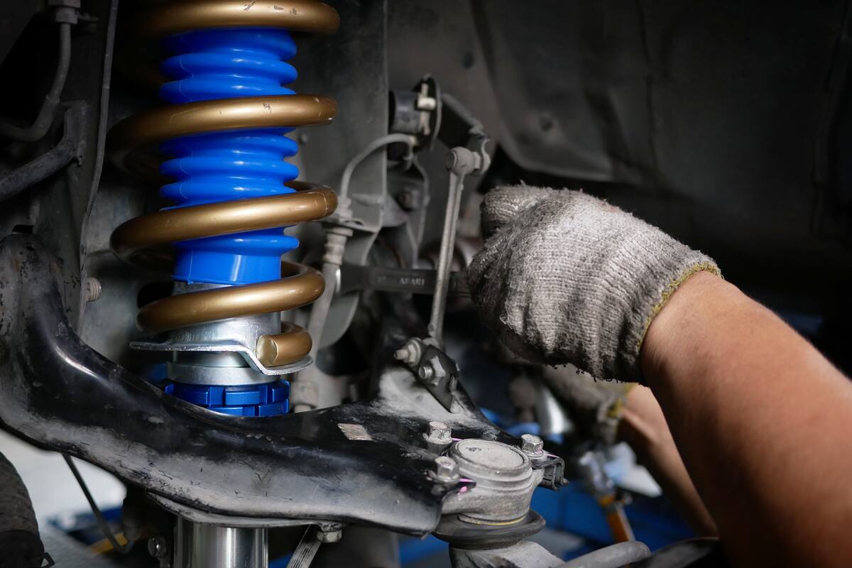 maintaining a car shock absorbers at garage.