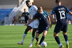 Majer cubre la pelota ante el asedio de Mohammed Kanno; espera Vlasic