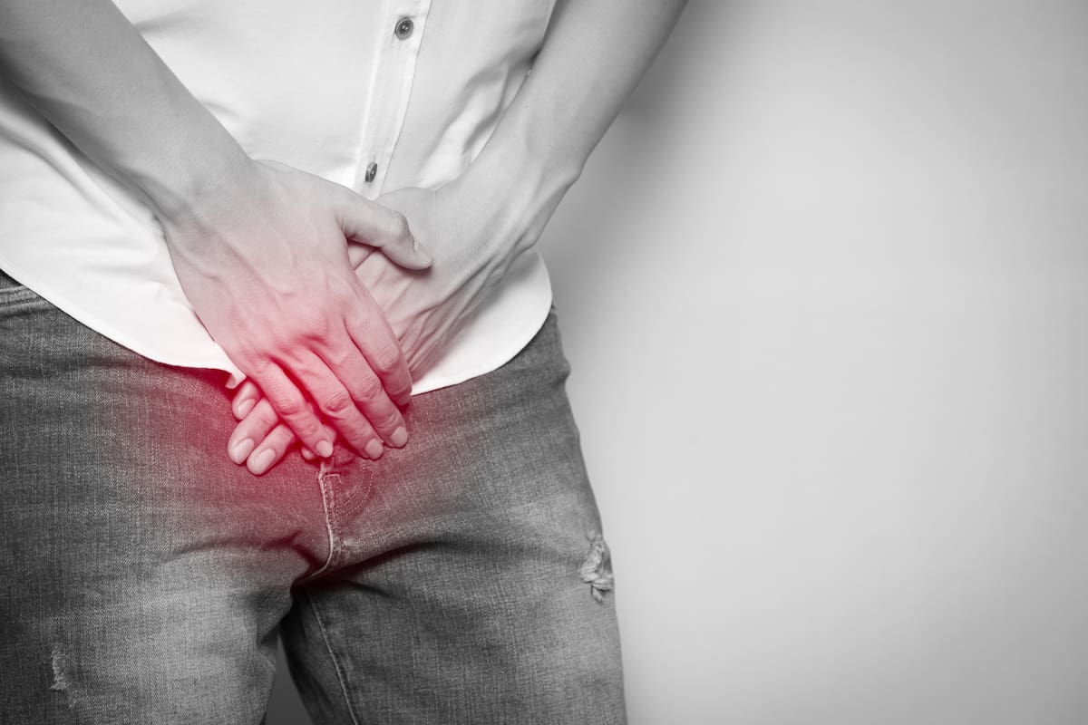 Male hands holding on middle crotch of trousers with prostate inflammation, Prostate cancer, Men's health care concept.