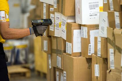 Male worker scanning barcode at warehouse.