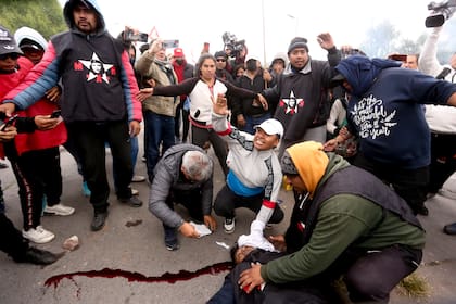 Manifestantes ayudan a una persona herida por la policía durante las manifestaciones contra la reforma constitucional del pasado 20 de junio en San Salvador de Jujuy