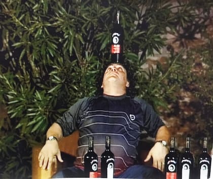 Maradona haciendo jueguito con una botella de su vino