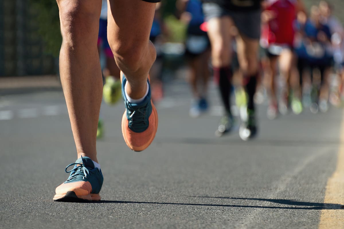 Marathon running race, people feet on city road