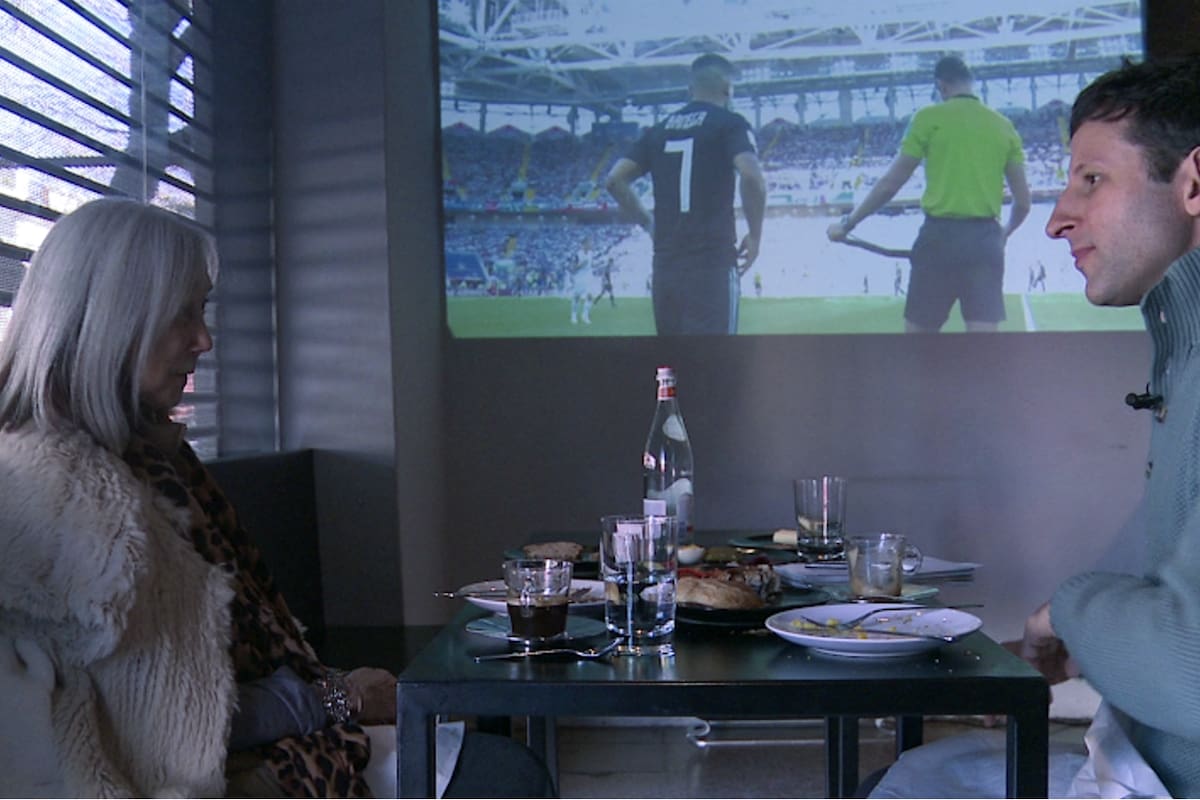 María Kodama charla con LA NACION; detrás, la transmisión de Argentina-Islandia