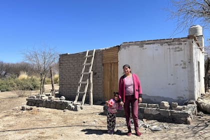 Mariana (su mamá) y su hermana Aurora frente a su casa de adobe; de fondo, los valles calchaquíes