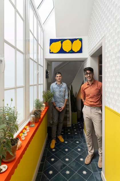 Mariano Daniel Manzi (izq.) y Juan Augusto Laplacette nos reciben en su casa. Tapiz con motivo de limones (An Ricagni)