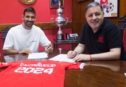 Martín Cauteruccio firmando su contrato con Independiente y a su lado Fabián Doman, presidente del club de Avellaneda