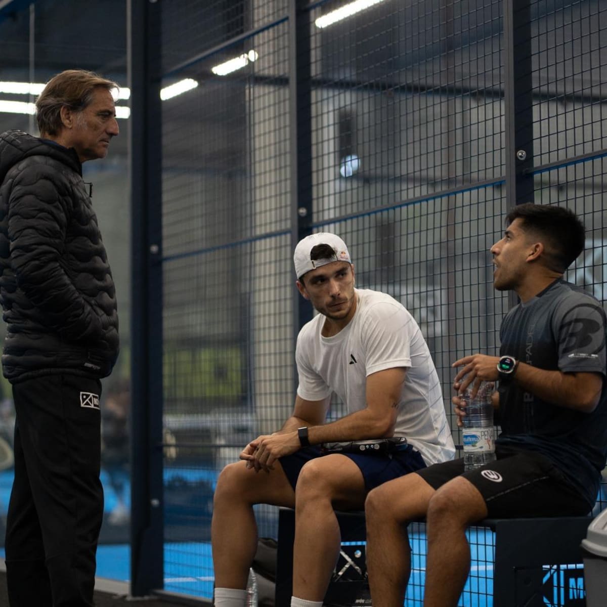 Coach Jorge Martínez discussing tactics with Galán and Chingotto during training