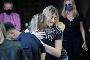 Martita Fort, custodiada por la niñera, Marisa, en el último adiós a Gustavo Martínez