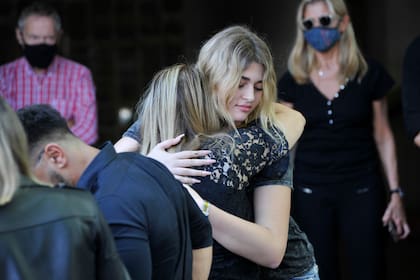 Martita Fort, custodiada por la niñera, Marisa, en el último adiós a Gustavo Martínez