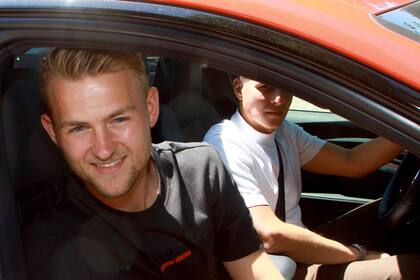 Matthijs de Ligt sonríe desde un auto tras retirarse de la sede del Bayern Múnich, el martes 19 de julio de 2022. (Mladen Lackovic/dpa vía AP)