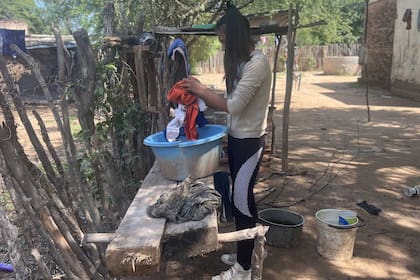 Mauricia tiene que cargar los baldes en la única canilla que tiene al frente de su casa para poder lavar la ropa, bañarse y tomar agua