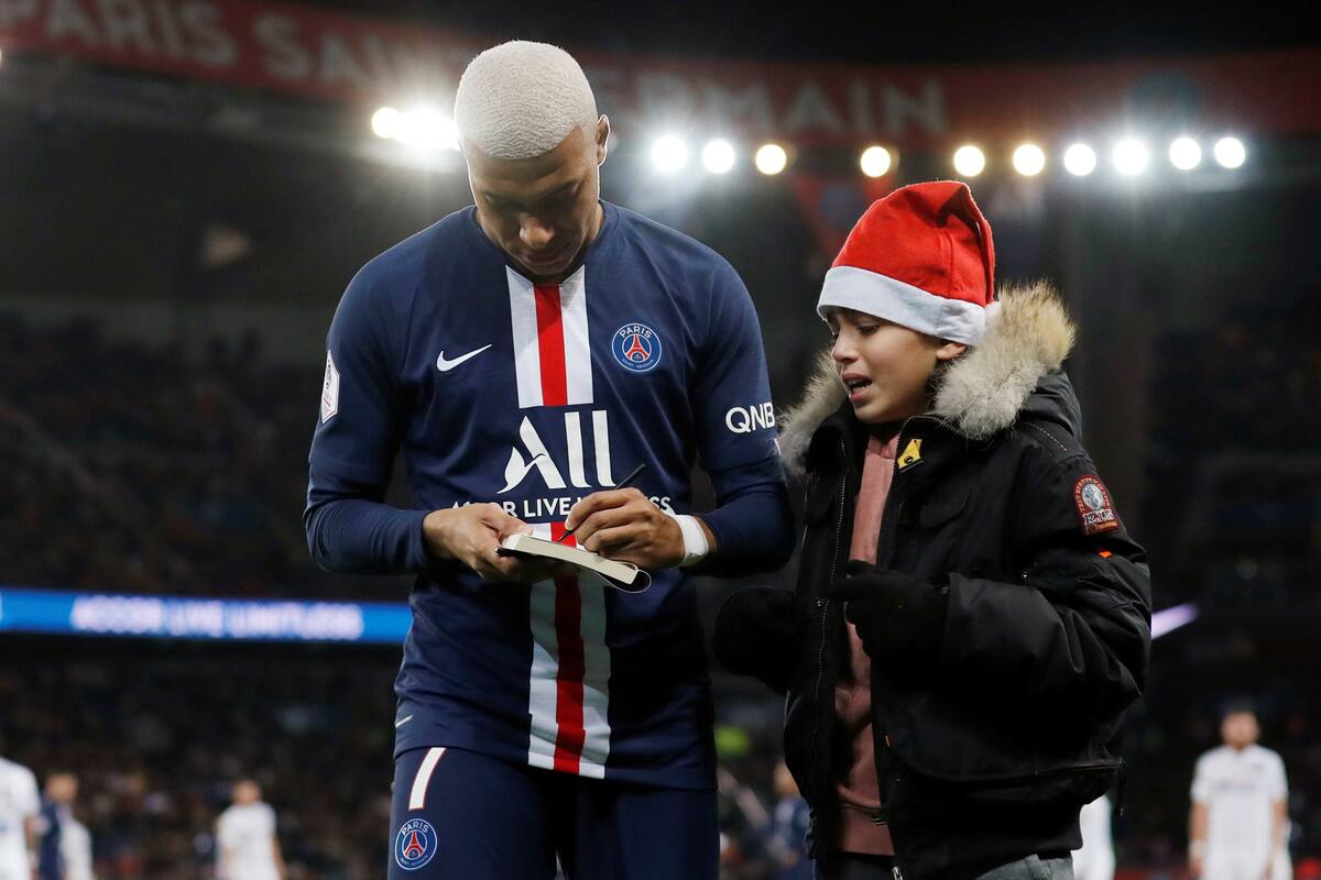 Mbappé le firma un autógrafo a un niño que se coló, durante un partido entre PSG y Amiens