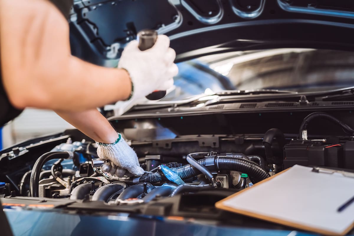 Mechanic man examining and maintenance to customer the engine a vehicle car hood, Safety inspection test engine before customer drive on a long journey, transportation repair service center