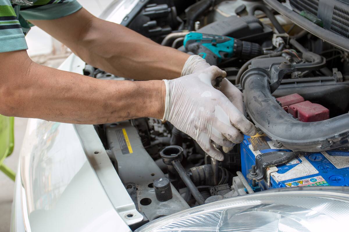mechanic repairs a car in a garage