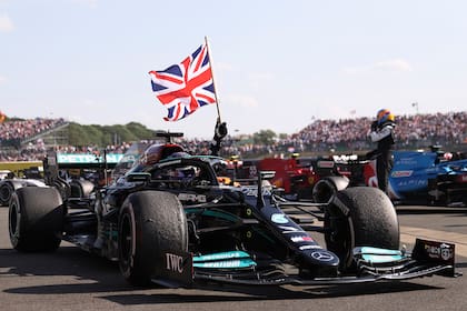 Mercedes driver Lewis Hamilton of Britain celebrates after winning the British Formula One Grand Prix, at the Silverstone circuit, in Silverstone, England, Sunday, July 18, 2021. (Lars Baron/Pool photo via AP)