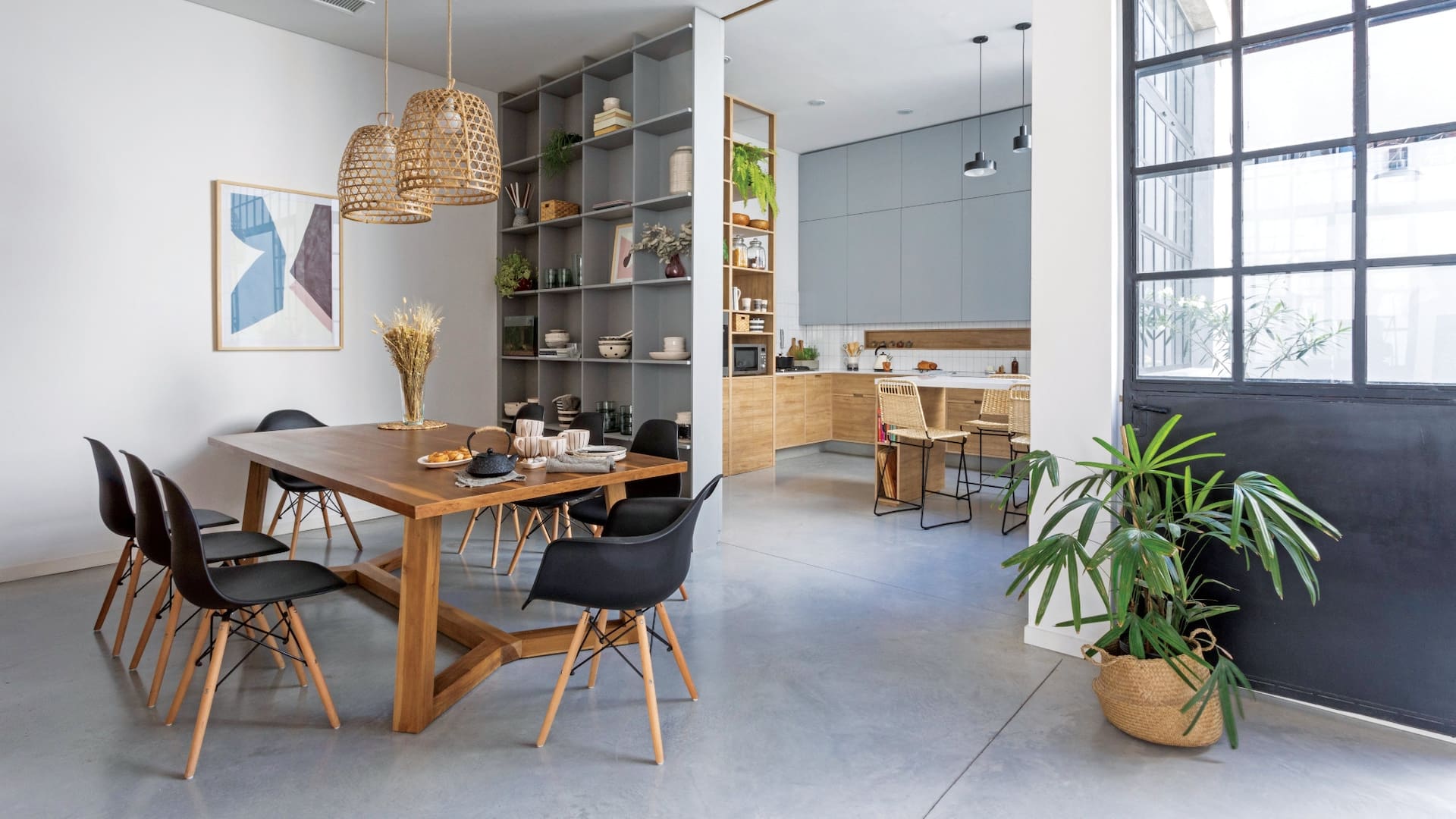Mesa ‘enna’ de madera maciza con tapa enchapada en petiribí (Cia Wood Ideas), sillas Eames ‘DSW’ (Del Sur Design), pantallas de bambú ‘Lola’ (Compañía Nativa) y acrílico enmarcado (Färg Art).