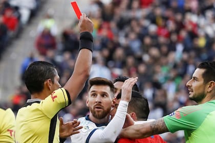 El árbitro Mario Díaz de Vivar les muestra la tarjeta roja a Lionel Messi y Gary Medel durante el partido entre Argentina y Chile por el tercer puesto de la Copa América de Brasil 2019.